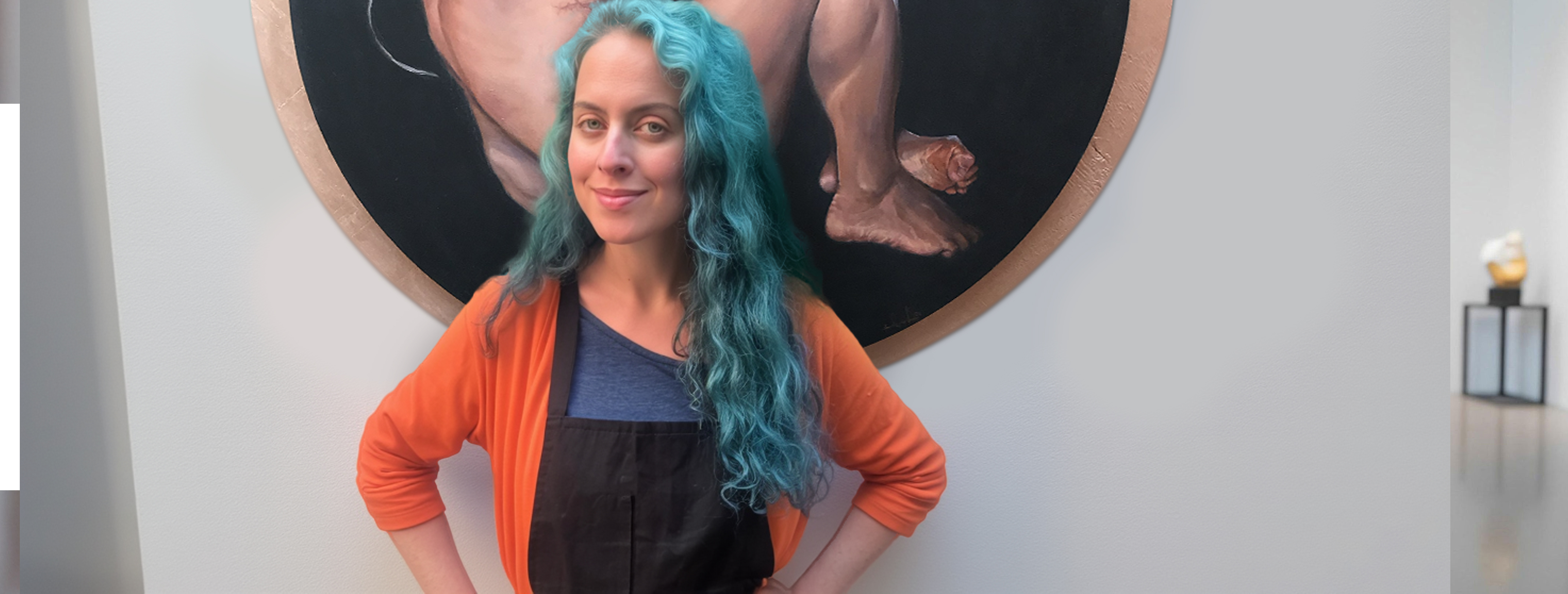 Eva Prada holding her artwork 'New Idols' in a wooden backdrop, showcasing her figurative art that explores technology and humanity